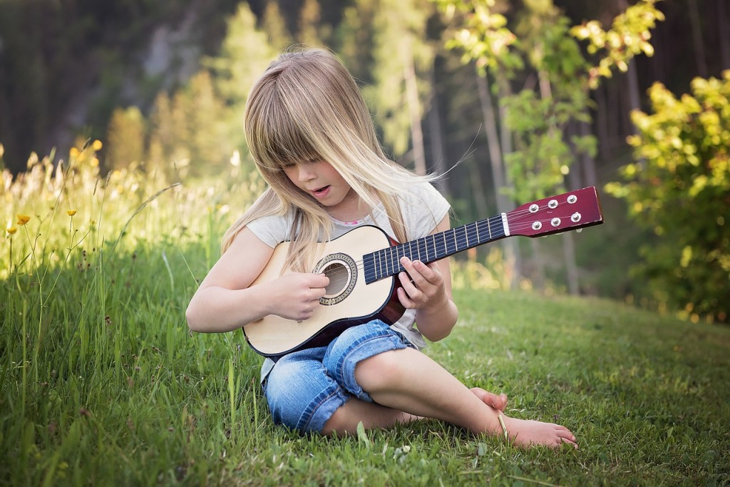 Little Girl Playing Toy Guitar